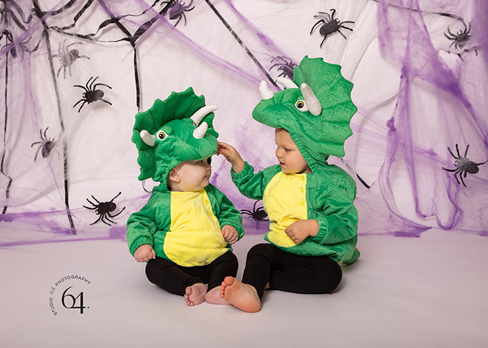 two youngs boys dinosaur costumes photographed in the studio