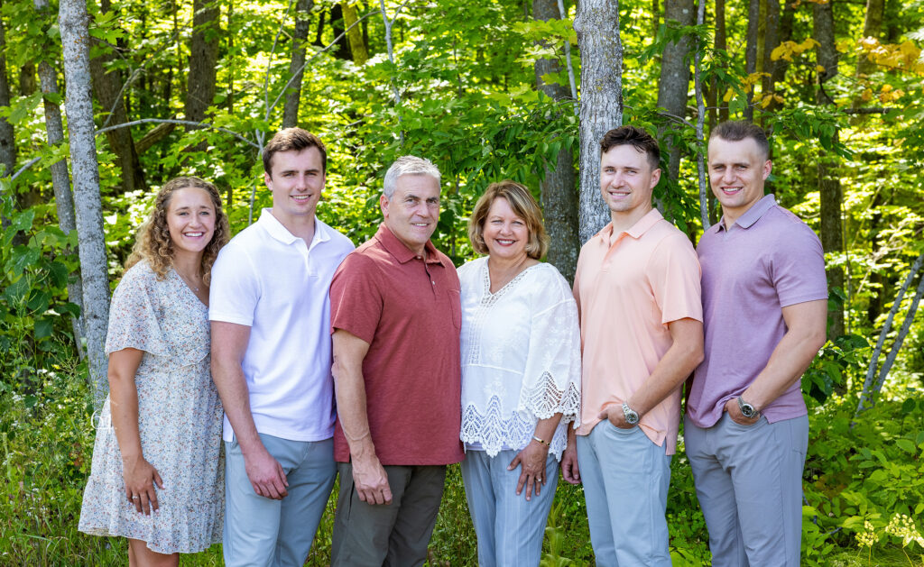 Large Extended Family outdoor portrait a summer forest backdrop.