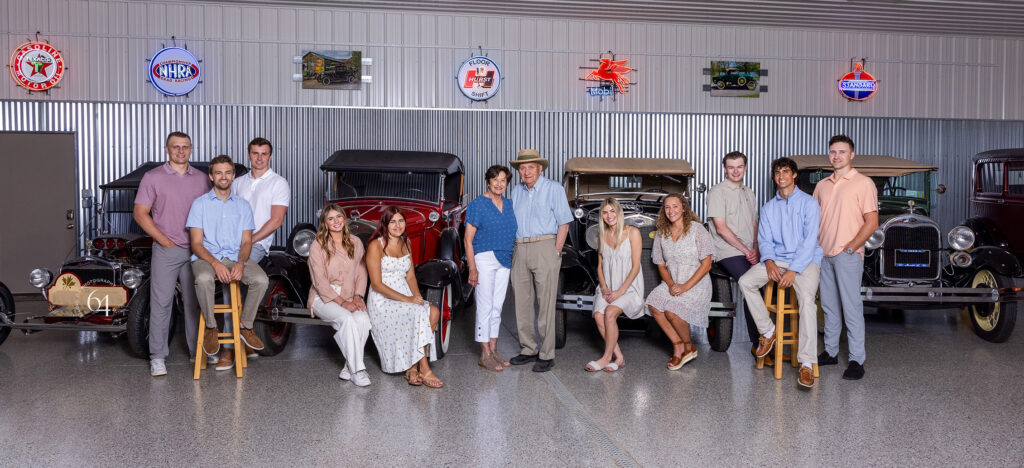 Large Extended Family Portrait with a Classic Cars Collection.